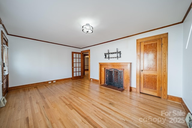 unfurnished living room with crown molding and light wood-type flooring