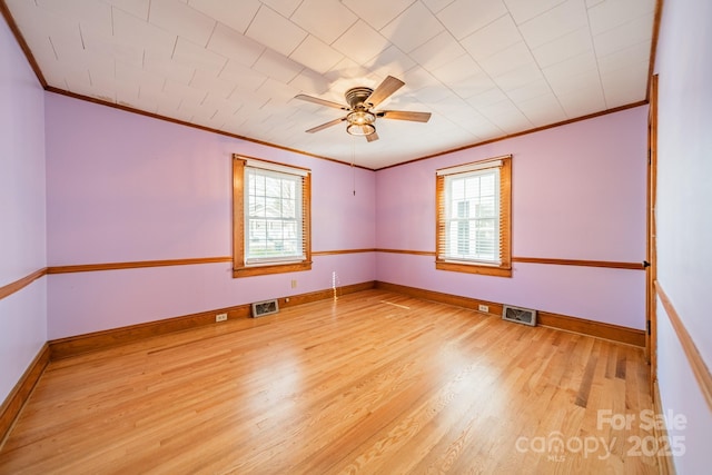 unfurnished room with ceiling fan, light hardwood / wood-style flooring, ornamental molding, and a healthy amount of sunlight