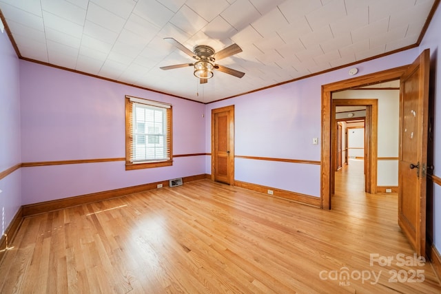 empty room with crown molding, ceiling fan, and light wood-type flooring