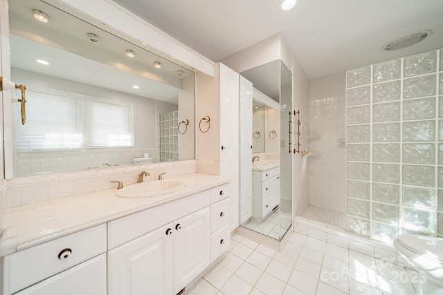 bathroom with vanity, tile patterned floors, and tiled shower