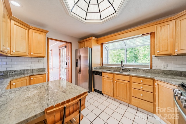 531 Elm St, Salisbury, NC 28144 - kitchen with stainless steel appliances, a sink, tasteful backsplash, light stone countertops, and light tile patterned floors