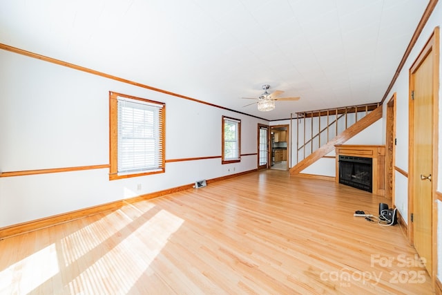 531 Elm St, Salisbury, NC 28144 - unfurnished living room with ornamental molding, wood finished floors, a ceiling fan, a fireplace, and baseboards