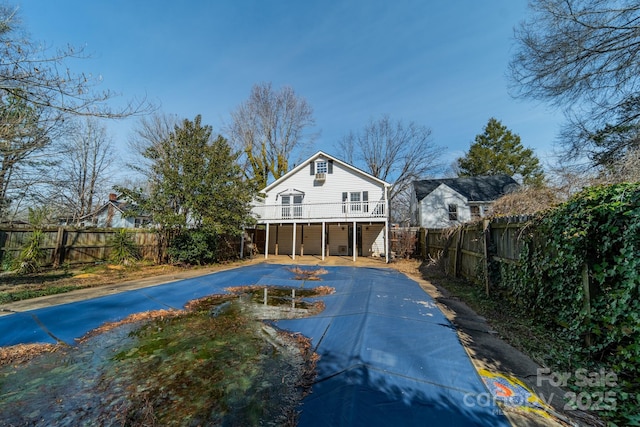 531 Elm St, Salisbury, NC 28144 - rear view of house featuring concrete driveway, stairway, a wooden deck, and a fenced backyard