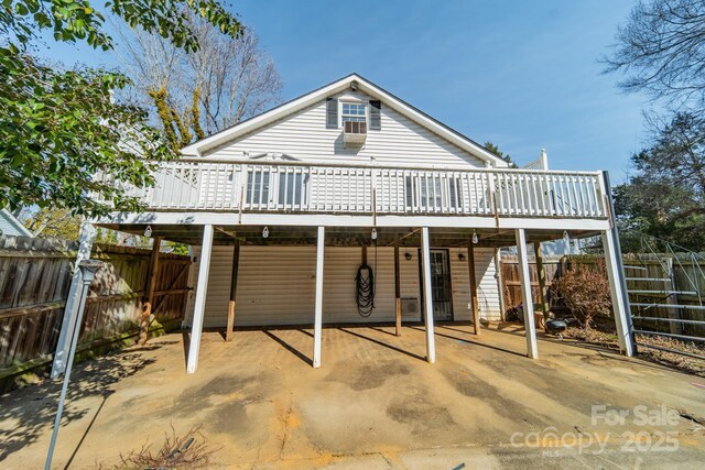 531 Elm St, Salisbury, NC 28144 - back of house featuring a deck, a carport, a fenced backyard, and a patio area