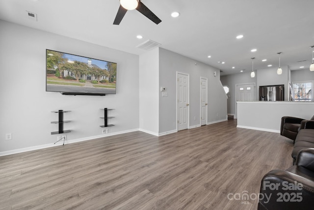 living room featuring ceiling fan and wood-type flooring