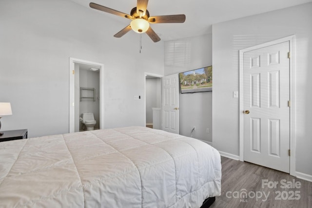 bedroom with ensuite bath, light hardwood / wood-style flooring, and ceiling fan