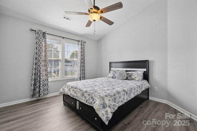 bedroom with dark wood-type flooring, vaulted ceiling, and ceiling fan