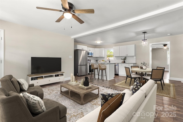 2525 Oxford Cir, Lancaster, SC 29720 - living room featuring ceiling fan, wood-type flooring, and sink