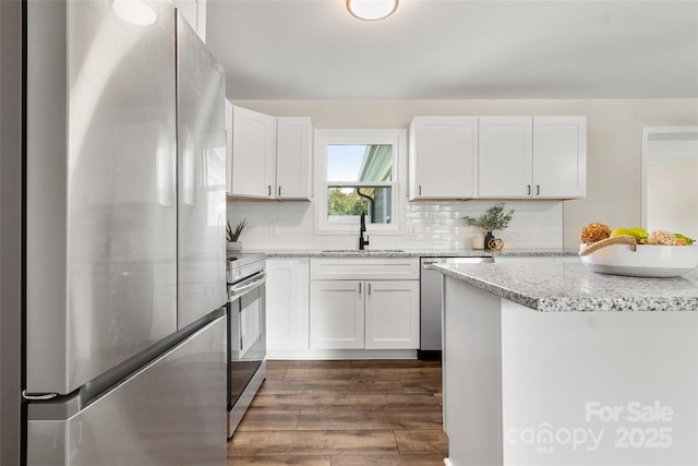 2525 Oxford Cir, Lancaster, SC 29720 - kitchen with sink, dark wood-type flooring, white cabinets, and appliances with stainless steel finishes