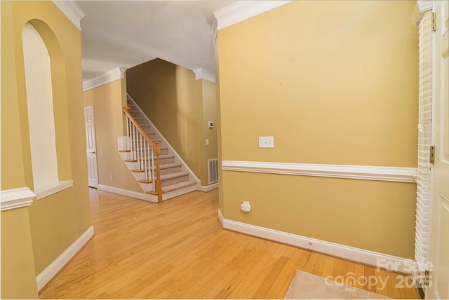 spare room featuring wood-type flooring and ornamental molding