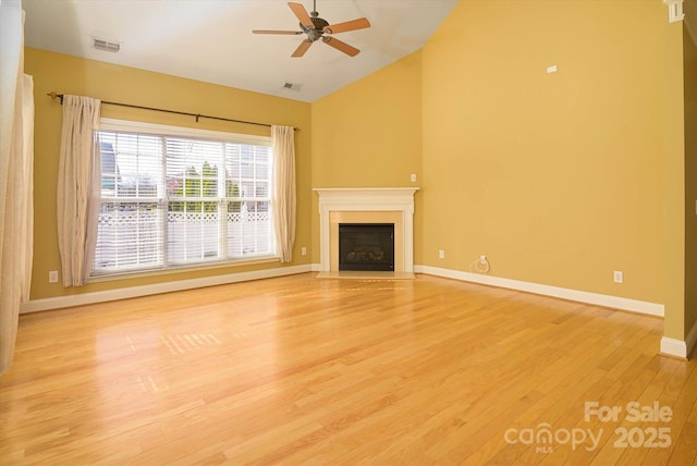 unfurnished living room featuring ceiling fan, vaulted ceiling, and light wood-type flooring