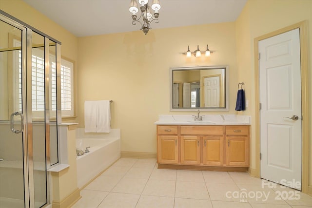 bathroom featuring vanity, tile patterned flooring, and separate shower and tub