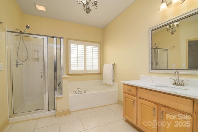 bathroom featuring vanity, tile patterned floors, and separate shower and tub