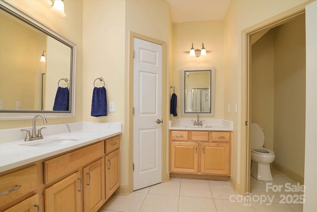 bathroom featuring tile patterned floors, toilet, and vanity