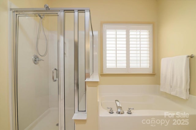 bathroom with separate shower and tub