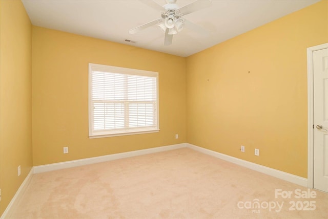 carpeted spare room with ceiling fan