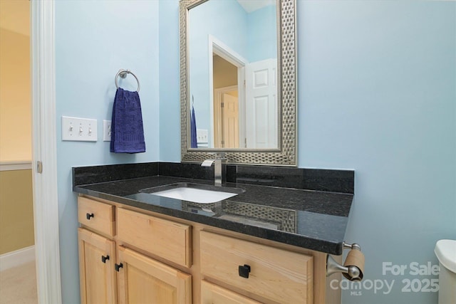 bathroom featuring vanity and toilet