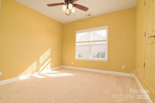 unfurnished room featuring light colored carpet and ceiling fan