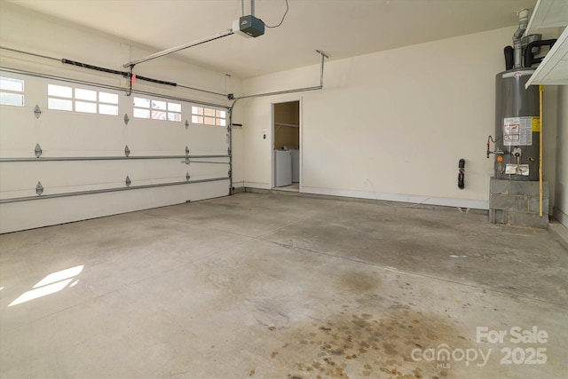 garage featuring washer and dryer, a garage door opener, and water heater