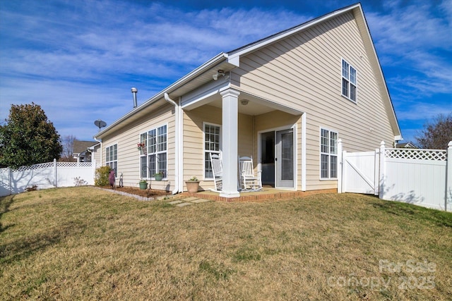 rear view of house with a yard