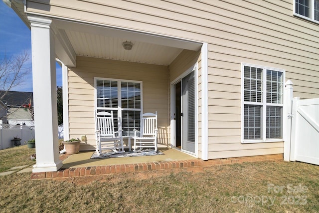 doorway to property featuring a lawn