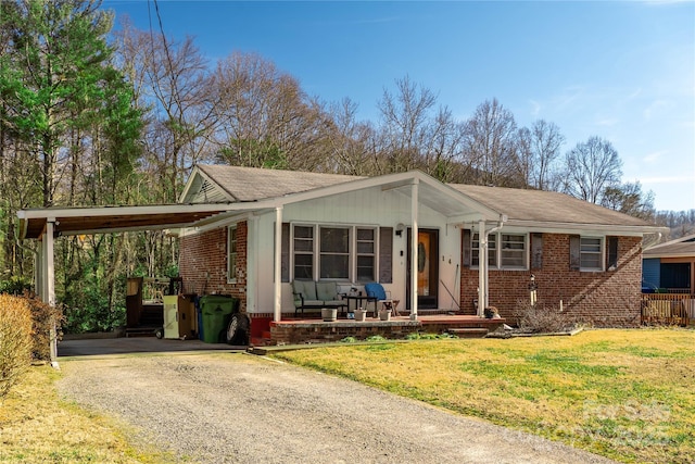 view of front of house with a carport and a front lawn