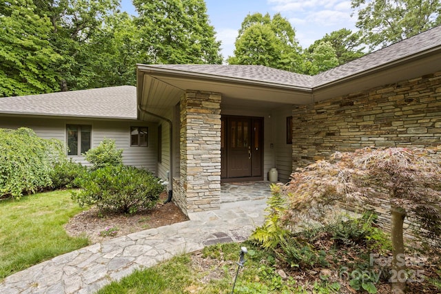 doorway to property with a lawn