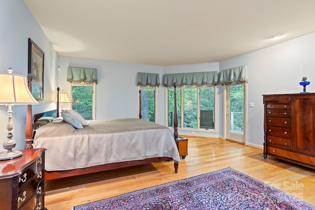 bedroom featuring access to exterior and light hardwood / wood-style floors