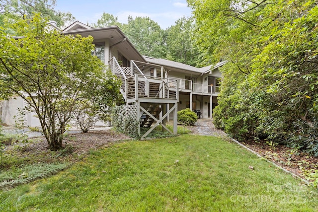 rear view of property featuring a lawn