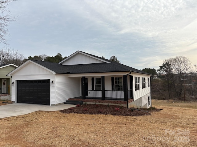 view of front of home with a garage, a front lawn, and a porch