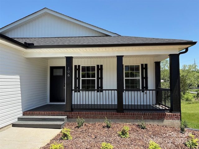 view of front of house featuring board and batten siding, a shingled roof, and covered porch