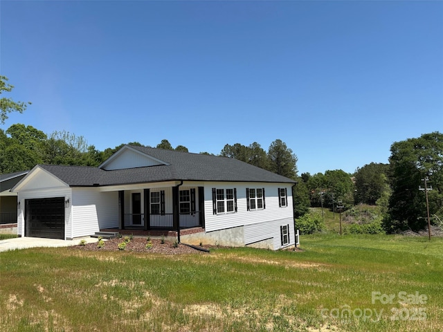 view of front of home with driveway, roof with shingles, an attached garage, a porch, and a front lawn