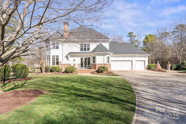 view of property with a garage and a front yard