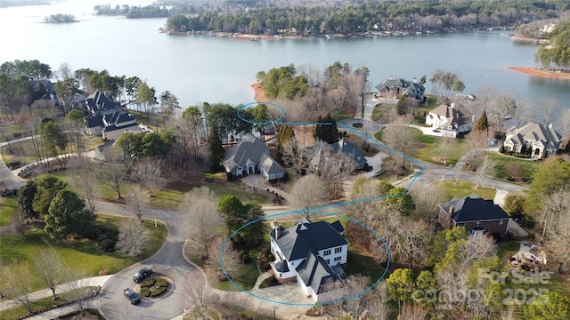 birds eye view of property with a water view