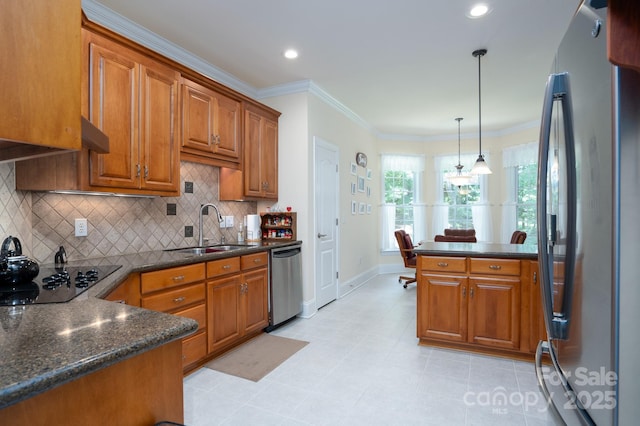 kitchen featuring appliances with stainless steel finishes, pendant lighting, sink, kitchen peninsula, and crown molding