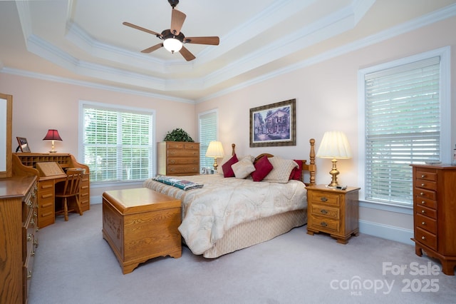 bedroom featuring ceiling fan, light colored carpet, ornamental molding, and a raised ceiling