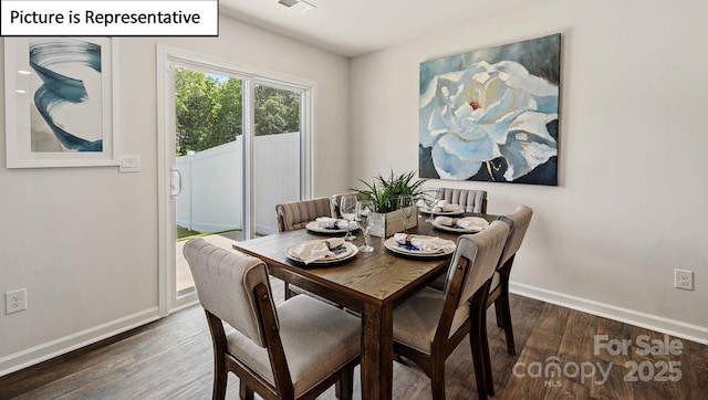 dining space with dark hardwood / wood-style floors