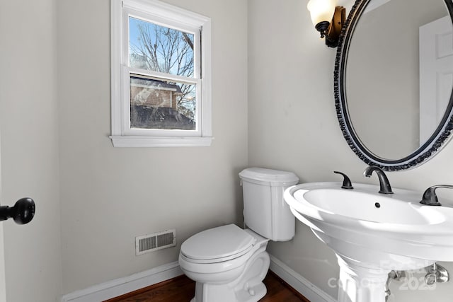 bathroom with sink, wood-type flooring, and toilet