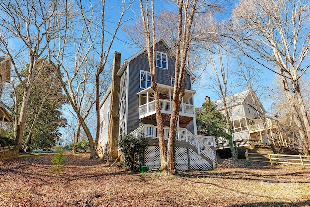 back of house featuring a balcony