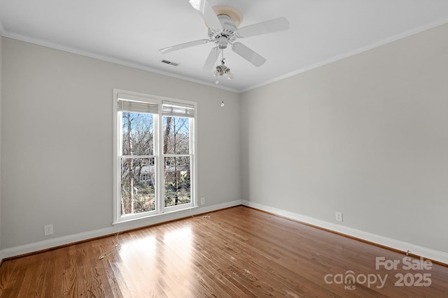 unfurnished room featuring hardwood / wood-style flooring, ornamental molding, and ceiling fan