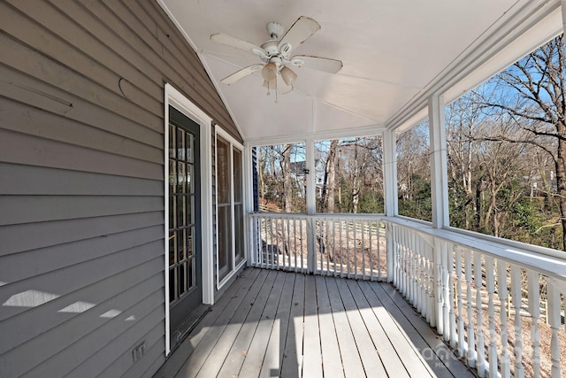 unfurnished sunroom with vaulted ceiling and ceiling fan