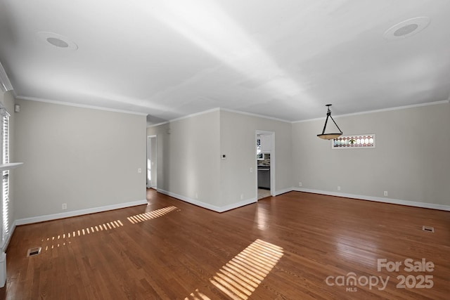 unfurnished living room with ornamental molding and dark wood-type flooring