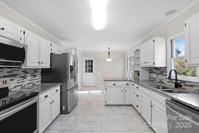 kitchen with sink, white cabinetry, decorative light fixtures, dark stone countertops, and stainless steel appliances