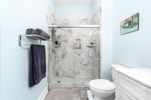 bathroom featuring vanity, an enclosed shower, and toilet