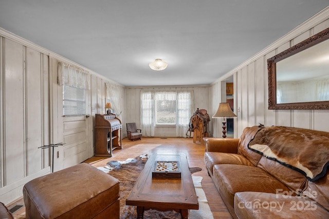 living room featuring ornamental molding and light wood-type flooring