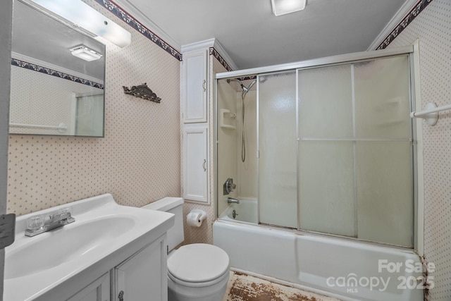 full bathroom with bath / shower combo with glass door, vanity, and toilet