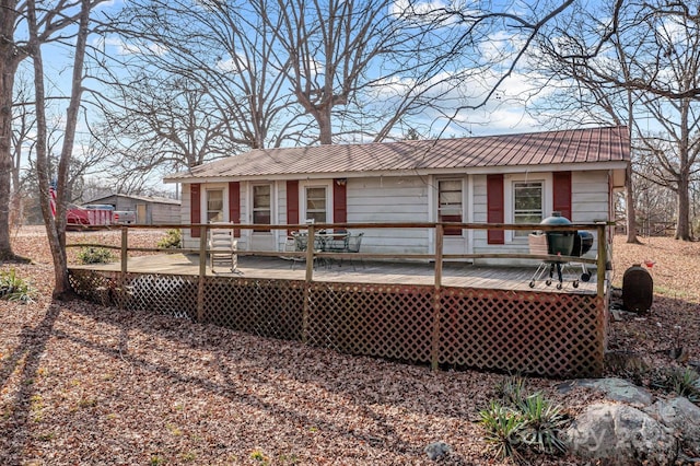 back of house with a wooden deck