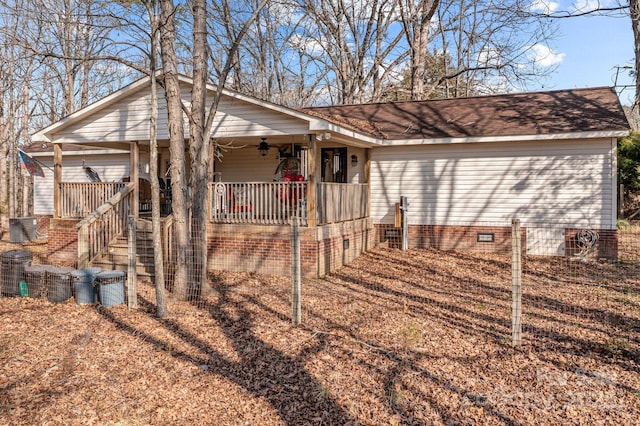 exterior space with central AC, ceiling fan, and covered porch