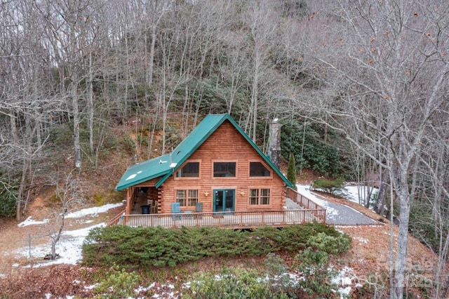 back of property with a wooden deck