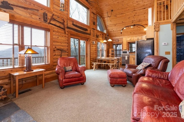175 Owl Lookout Rd, Sylva, NC 28779 - carpeted living room with log walls, plenty of natural light, and a high ceiling